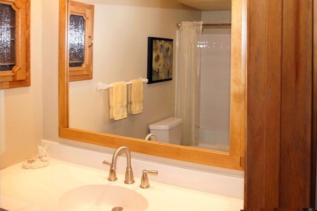 full bathroom with toilet and vanity