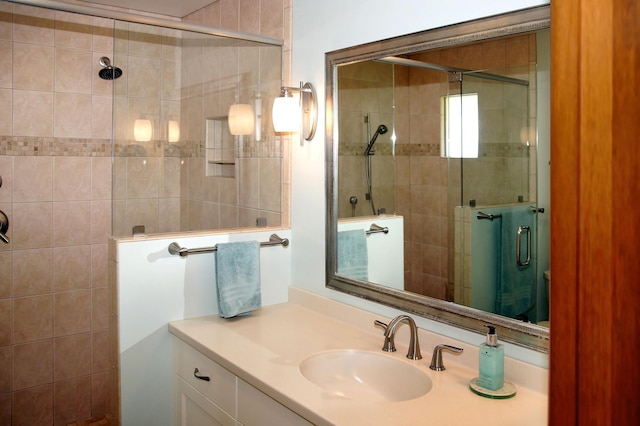 bathroom featuring a shower stall and vanity