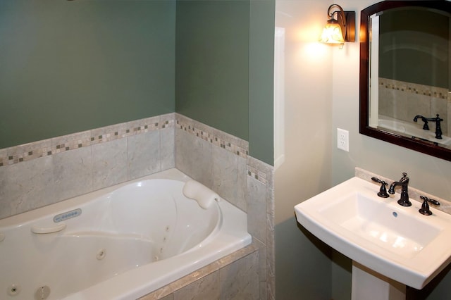 bathroom with a sink and a tub with jets