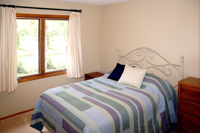 bedroom with carpet flooring and baseboards