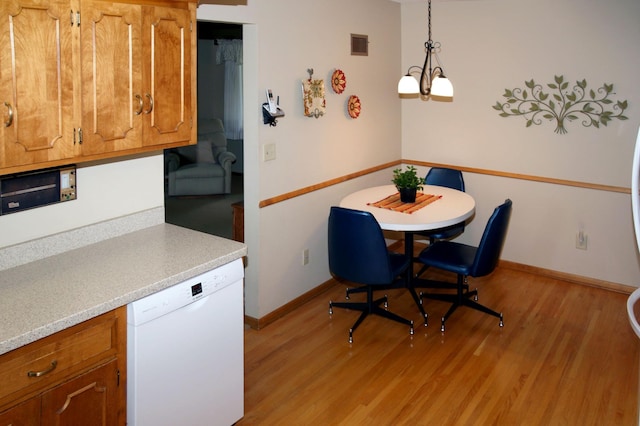 dining room featuring light wood-style flooring and baseboards