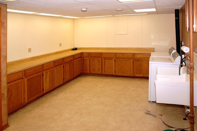 washroom featuring cabinet space and washing machine and clothes dryer