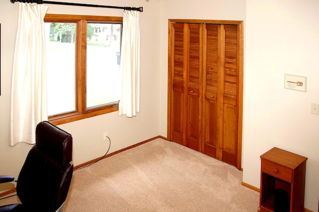 carpeted office space featuring baseboards