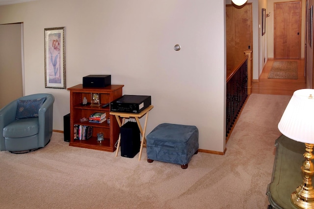 living area featuring carpet floors and baseboards