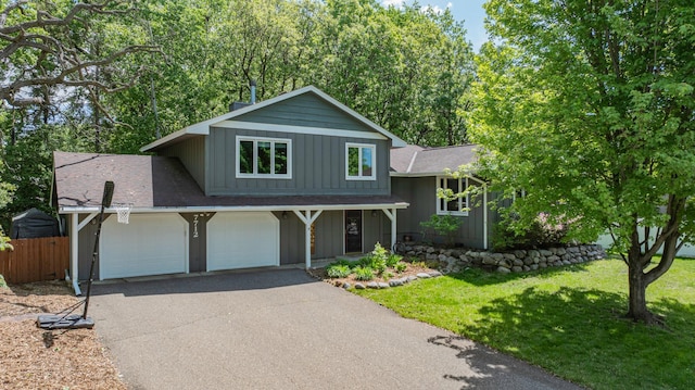 7712 Bester Ave, Inver Grove Heights, MN 55076 - split level home with board and batten siding, asphalt driveway, and a shingled roof