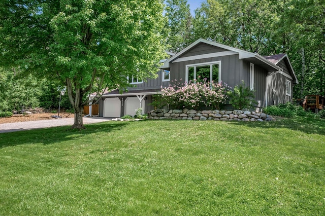 7712 Bester Ave, Inver Grove Heights, MN 55076 - view of front of home featuring concrete driveway, a front lawn, board and batten siding, and a garage