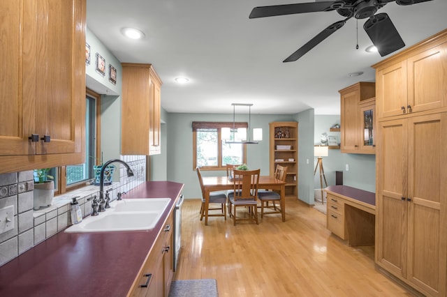 7712 Bester Ave, Inver Grove Heights, MN 55076 - kitchen featuring a sink, dark countertops, a ceiling fan, light wood-style flooring, and stainless steel dishwasher