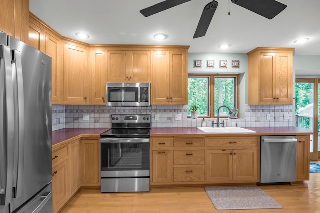 7712 Bester Ave, Inver Grove Heights, MN 55076 - kitchen featuring stainless steel appliances, a sink, a ceiling fan, and light wood-style floors