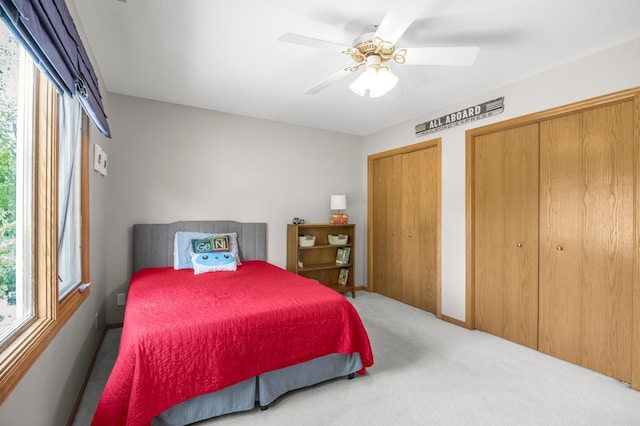 7712 Bester Ave, Inver Grove Heights, MN 55076 - carpeted bedroom featuring multiple windows, multiple closets, and a ceiling fan