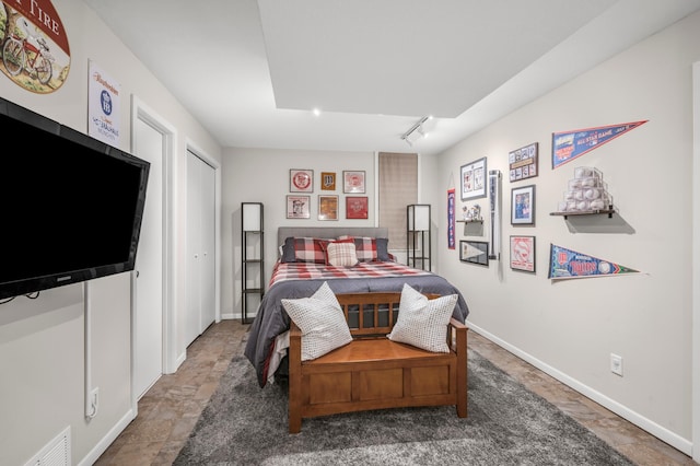 7712 Bester Ave, Inver Grove Heights, MN 55076 - bedroom with stone finish floors, track lighting, and baseboards