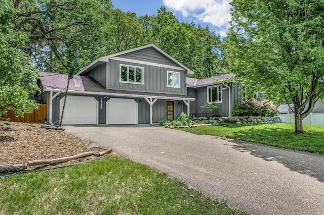 7712 Bester Ave, Inver Grove Heights, MN 55076 - split level home with board and batten siding, asphalt driveway, and an attached garage