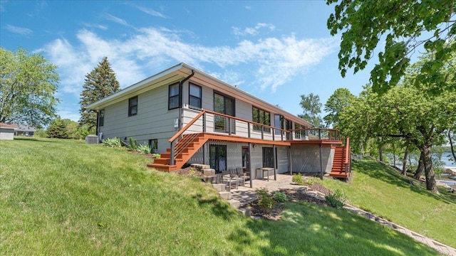 1219 Latoka Dr SW, Alexandria, MN 56308 - rear view of property with stairway, a deck, a patio, central AC, and a lawn