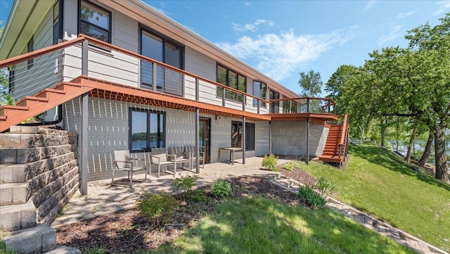 1219 Latoka Dr SW, Alexandria, MN 56308 - rear view of property featuring stairs, a wooden deck, a yard, and a patio area