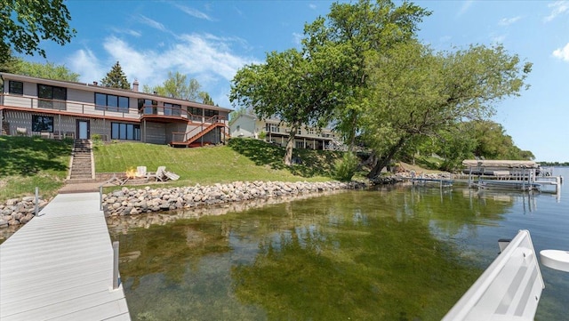 1219 Latoka Dr SW, Alexandria, MN 56308 - dock featuring stairs, a lawn, an outdoor fire pit, and a deck with water view