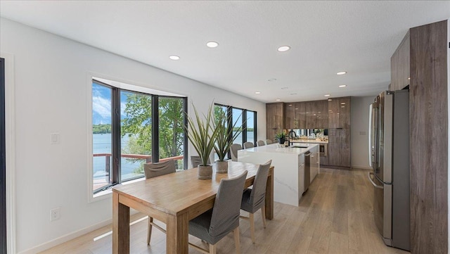 1219 Latoka Dr SW, Alexandria, MN 56308 - dining room with recessed lighting, light wood-style floors, baseboards, and a water view