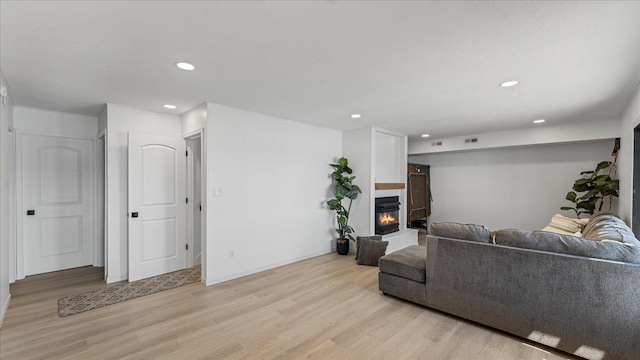 1219 Latoka Dr SW, Alexandria, MN 56308 - living area featuring light wood-style flooring, recessed lighting, and a lit fireplace