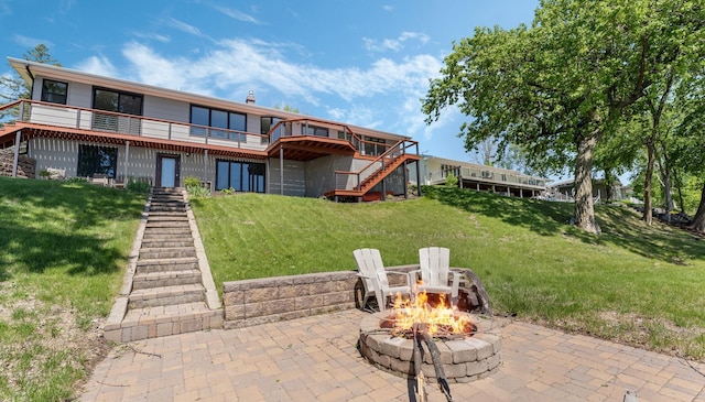 1219 Latoka Dr SW, Alexandria, MN 56308 - back of property with stairway, a fire pit, a deck, and a patio