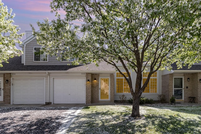 8766 Benson Way Unit 84, Inver Grove Heights, MN 55076 - view of front of home featuring brick siding, driveway, and a shingled roof