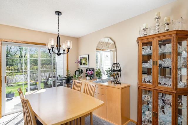 8766 Benson Way Unit 84, Inver Grove Heights, MN 55076 - dining space featuring a chandelier, healthy amount of natural light, and light colored carpet