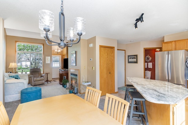 8766 Benson Way Unit 84, Inver Grove Heights, MN 55076 - dining space with a chandelier, light carpet, and track lighting