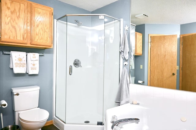 8766 Benson Way Unit 84, Inver Grove Heights, MN 55076 - bathroom with a textured ceiling, a shower stall, a garden tub, and toilet