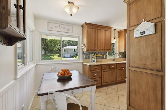5240 Birch Rd, Minnetonka, MN 55345 - kitchen featuring brown cabinetry, light countertops, a sink, and tasteful backsplash
