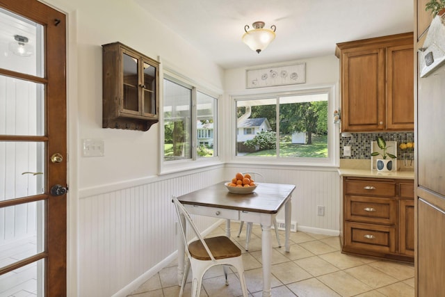 5240 Birch Rd, Minnetonka, MN 55345 - dining space with a wainscoted wall and light tile patterned floors