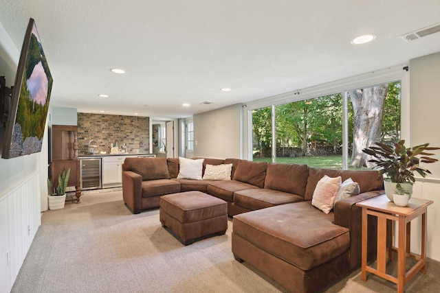 5240 Birch Rd, Minnetonka, MN 55345 - living area featuring wine cooler, bar with sink, healthy amount of natural light, light colored carpet, and recessed lighting