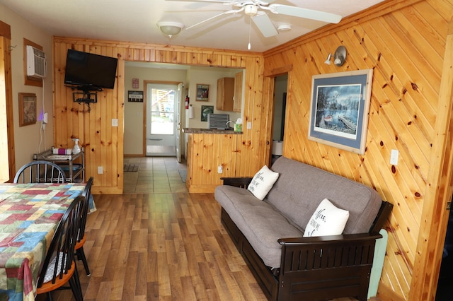 39887 195th St, Clitherall Twp, MN 56524 - living room with wood walls, wood finished floors, ceiling fan, and baseboards