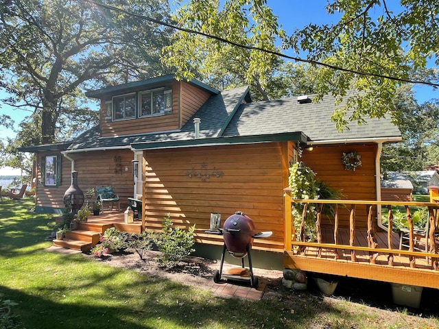 23979 Navajo Trl, Henning, MN 56551 - back of property with roof with shingles, a deck, and a yard