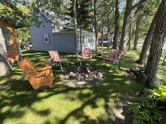 23979 Navajo Trl, Henning, MN 56551 - view of green lawn featuring an outdoor fire pit