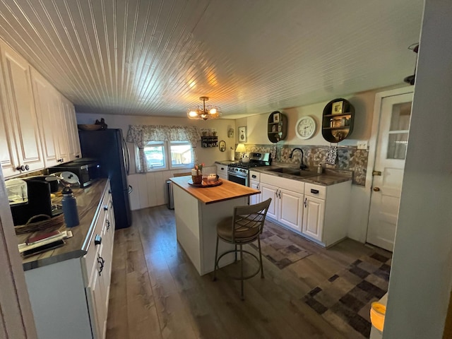 23979 Navajo Trl, Henning, MN 56551 - kitchen featuring appliances with stainless steel finishes, wood counters, white cabinets, a sink, and a chandelier