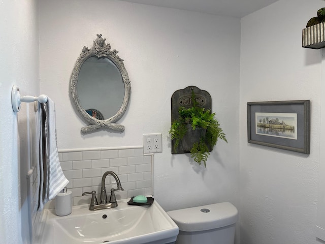23979 Navajo Trl, Henning, MN 56551 - bathroom with a sink, toilet, and tile walls