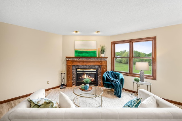 4277 Oakmede Ln Unit 62C, White Bear Twp, MN 55110 - living room with baseboards, a high end fireplace, a textured ceiling, and wood finished floors
