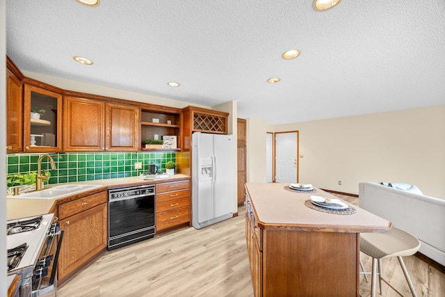 4277 Oakmede Ln Unit 62C, White Bear Twp, MN 55110 - kitchen featuring white fridge with ice dispenser, dishwasher, a sink, gas range, and open shelves