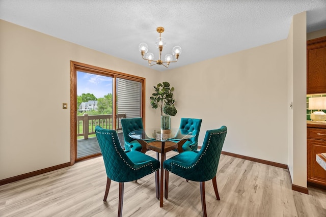 4277 Oakmede Ln Unit 62C, White Bear Twp, MN 55110 - dining area featuring a chandelier, light wood finished floors, baseboards, and a textured ceiling