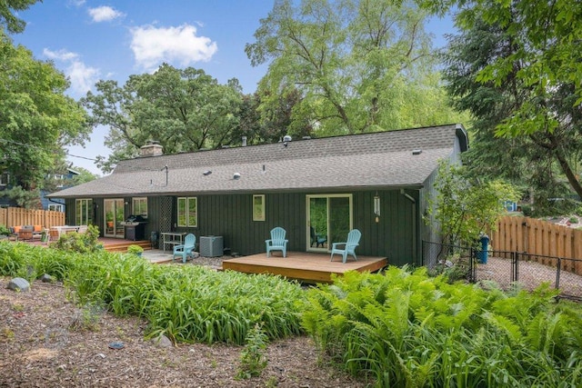 4744 Westgate Rd, Minnetonka, MN 55345 - back of property with a deck, roof with shingles, a chimney, and board and batten siding