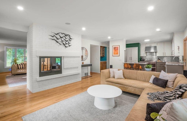 4744 Westgate Rd, Minnetonka, MN 55345 - living area featuring light wood-style flooring, a brick fireplace, and recessed lighting