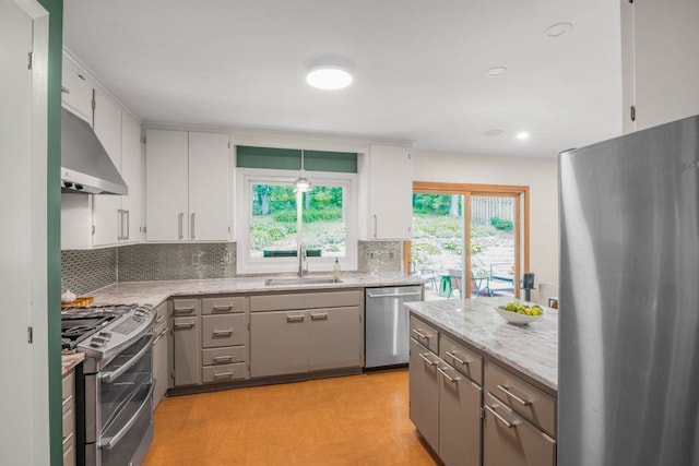 4744 Westgate Rd, Minnetonka, MN 55345 - kitchen featuring stainless steel appliances, ventilation hood, backsplash, white cabinetry, and recessed lighting