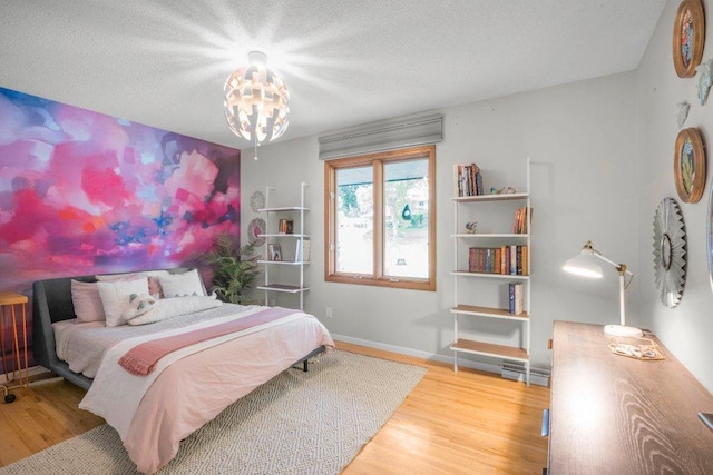 4744 Westgate Rd, Minnetonka, MN 55345 - bedroom with wood finished floors, a chandelier, and a textured ceiling