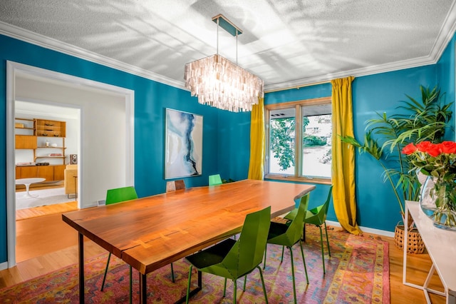 4744 Westgate Rd, Minnetonka, MN 55345 - dining space featuring a textured ceiling, a chandelier, ornamental molding, and wood finished floors
