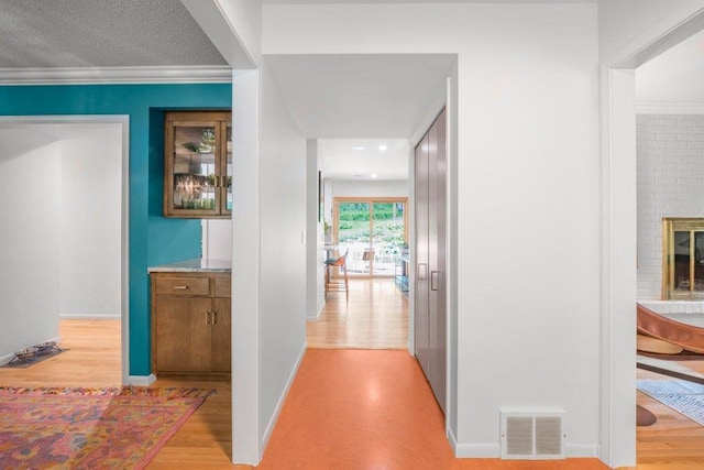 4744 Westgate Rd, Minnetonka, MN 55345 - hallway featuring light wood-type flooring and crown molding