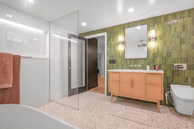 4744 Westgate Rd, Minnetonka, MN 55345 - full bath featuring tile walls, speckle patterned floor, vanity, a freestanding bath, and recessed lighting