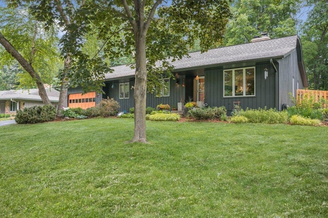 4744 Westgate Rd, Minnetonka, MN 55345 - ranch-style house featuring board and batten siding, a front lawn, a garage, a chimney, and a shingled roof