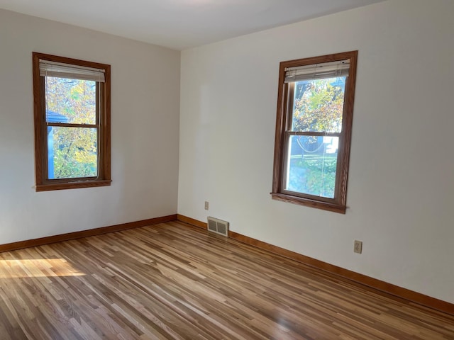 unfurnished room featuring wood finished floors and baseboards