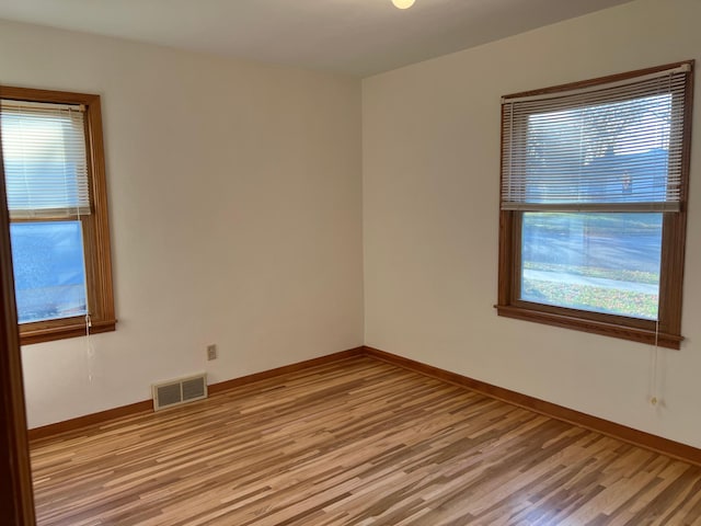 unfurnished room featuring light wood-type flooring and baseboards