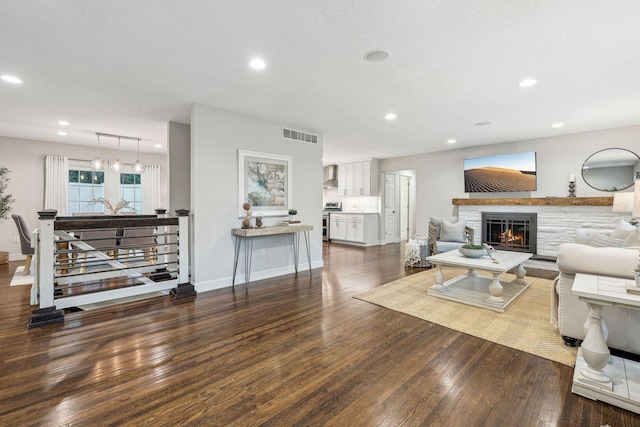 5078 Vine Hill Rd, Deephaven, MN 55331 - living area with wood finished floors, recessed lighting, a glass covered fireplace, baseboards, and a chandelier