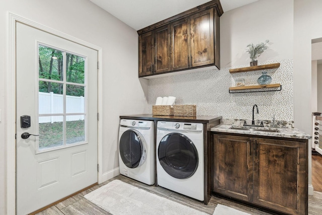 5078 Vine Hill Rd, Deephaven, MN 55331 - washroom with washer and clothes dryer, cabinet space, light wood-style flooring, and baseboards
