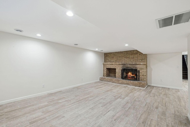 5078 Vine Hill Rd, Deephaven, MN 55331 - unfurnished living room with a brick fireplace, light wood-style floors, recessed lighting, and baseboards