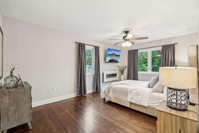 5078 Vine Hill Rd, Deephaven, MN 55331 - bedroom featuring wood finished floors, baseboards, a glass covered fireplace, and ceiling fan